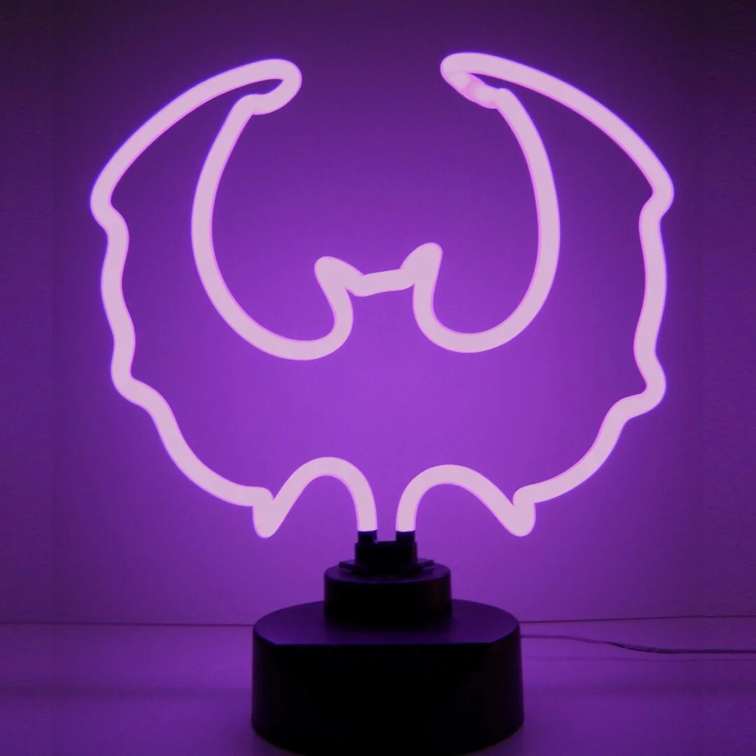 Purple Bat Neon Sculpture with hand-blown neon tubing on a black display base