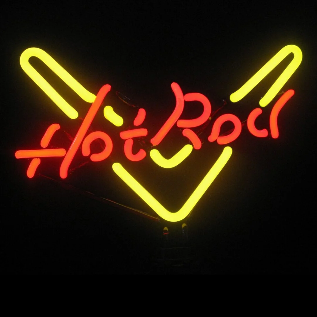 Hot Rod neon sculpture with bright lettering and yellow accents