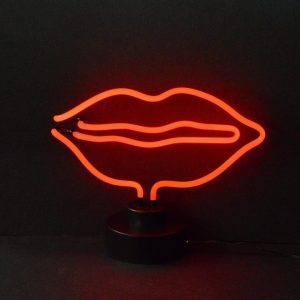 Red lips neon sculpture on a black display base