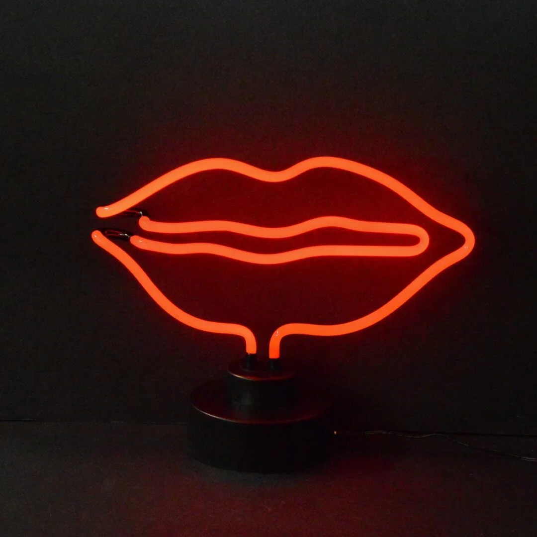 Red lips neon sculpture on a black display base